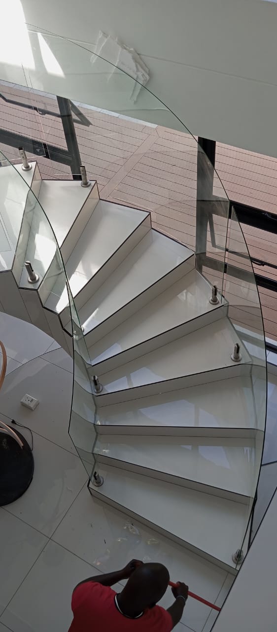 Curved frameless glass staircase balustrade installed by Tshwane Metal